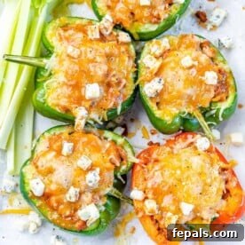 Top view of chicken stuffed peppers topped with blue cheese crumble