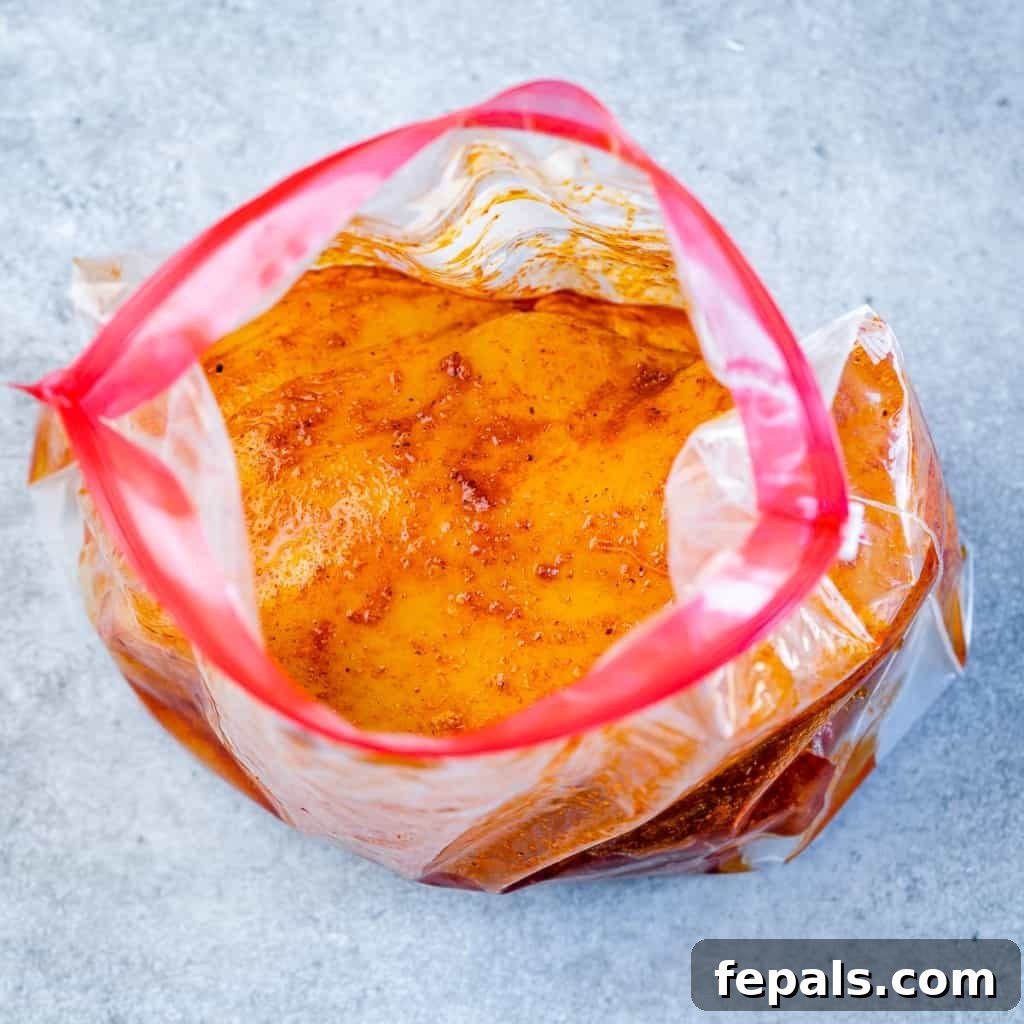 Chicken marinating in a ziplock bag.