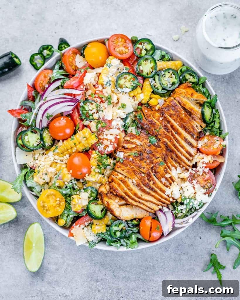 top view of chicken arugula salad in a bowl