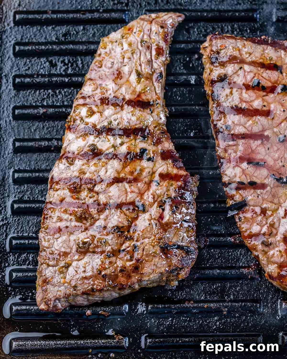 Grilled Flank Steak Recipe with Pineapple flank steak on grill