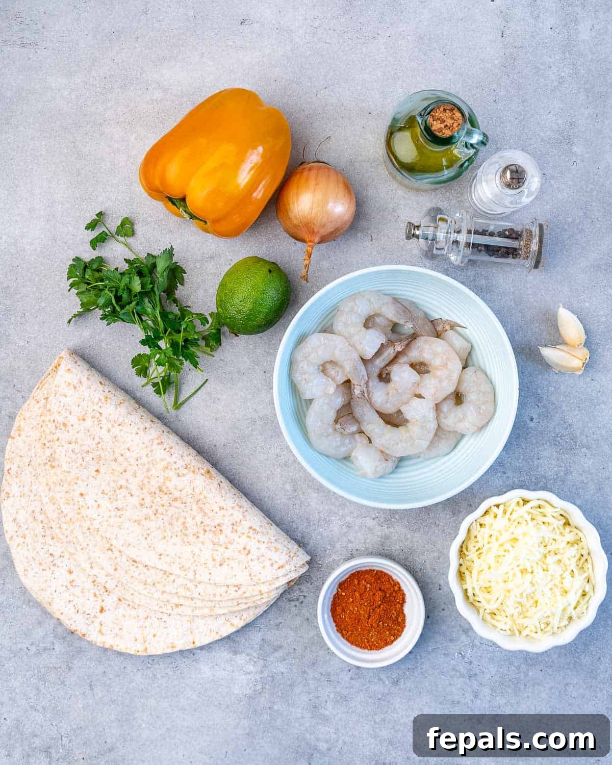 Seafood Mexican-style Quesadilla Recipe flour tortillas, taco seasoning, mozzarella cheese, raw shrimp, garlic cloves, salt, pepper, olive oil, onion, lime, orange bell pepper, parsley on grey surface