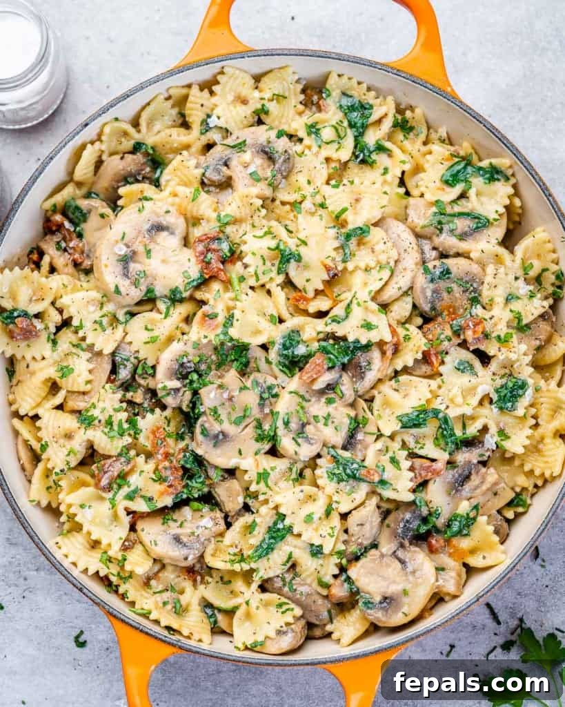 top view spinach and mushroom pasta, perfectly cooked and garnished