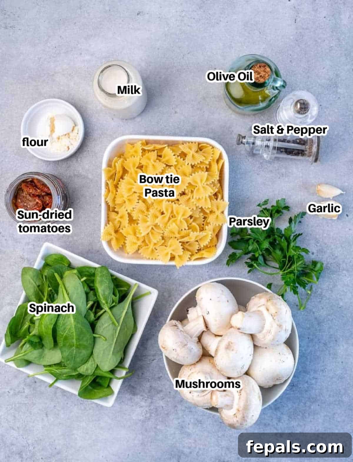 ingredients to make mushroom and spinach pasta, neatly arranged on a counter