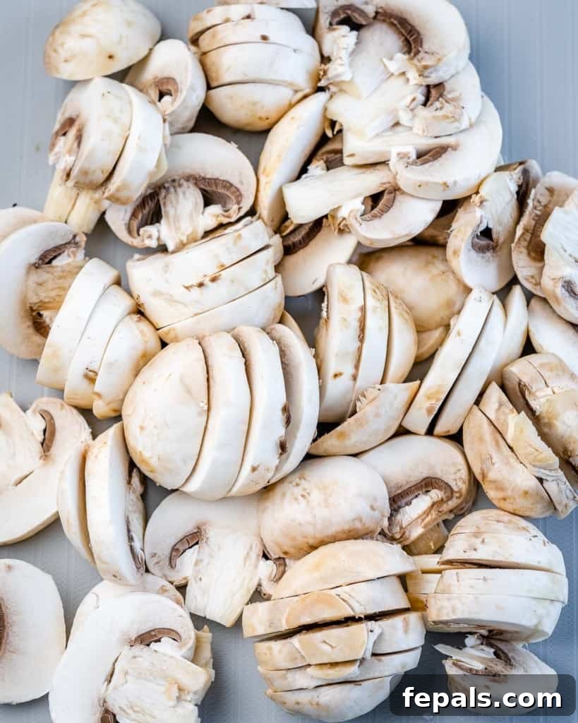 chopped mushrooms being sauteed in a pan
