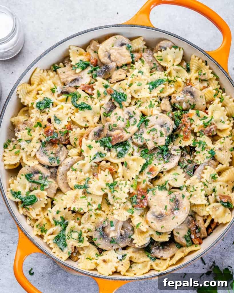 top view of mushroom pasta in a large skillet, ready to be served