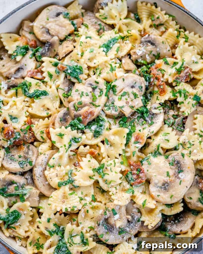 close up mushroom and spinach pasta recipe, showing detailed texture