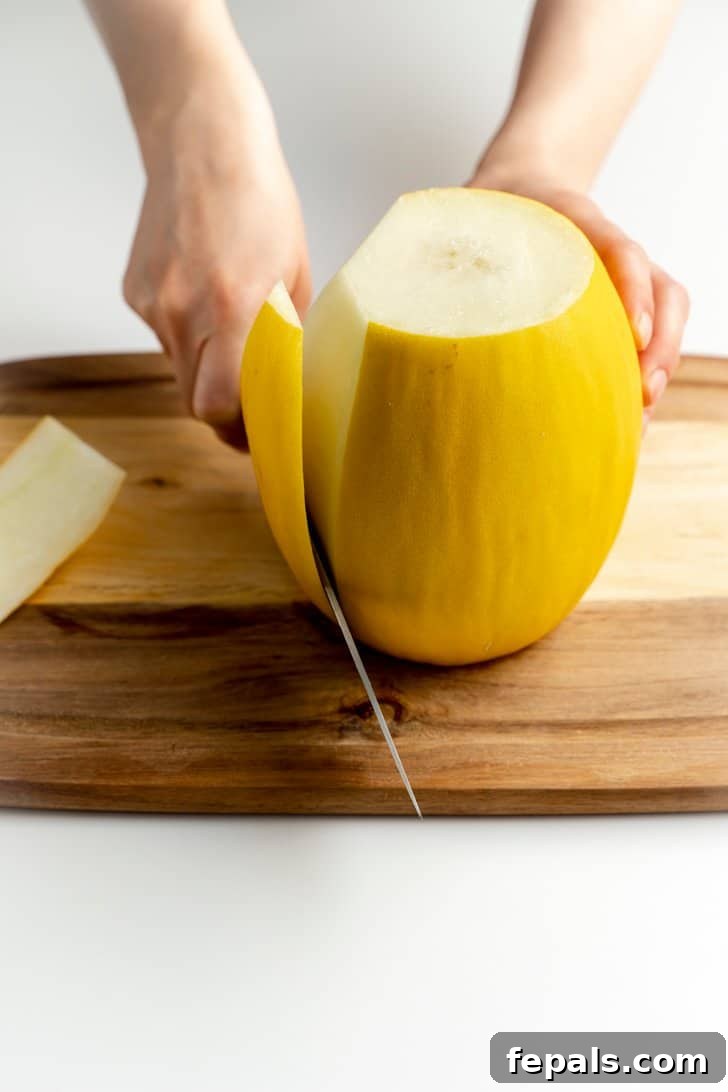 cutting the peel off a cantaloupe with knife