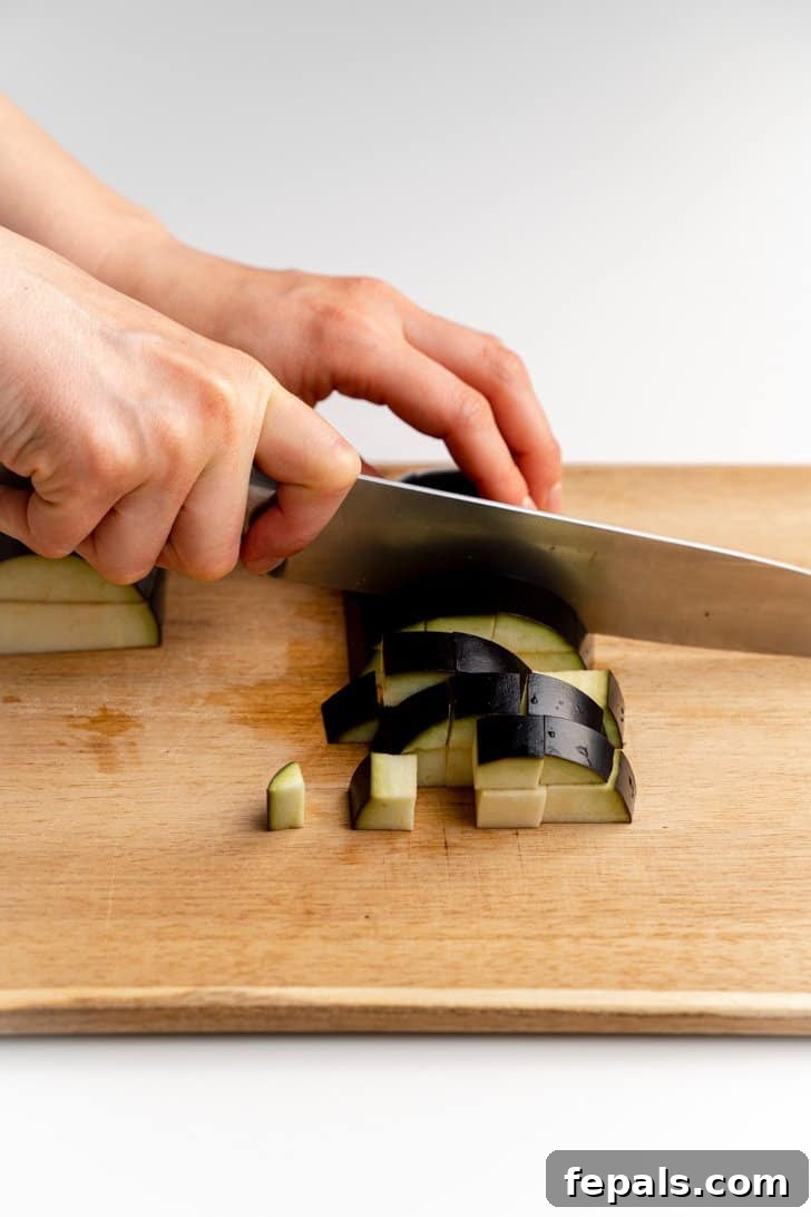 Precision Dicing of Eggplant Dicing the eggplant strips crosswise into perfectly sized cubes.