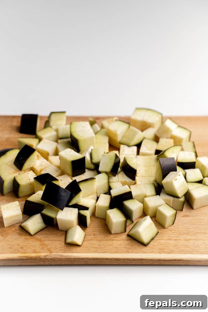 Bowl of Cubed Eggplant A bowl filled with freshly cubed and diced eggplant pieces.