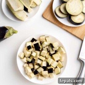 Sliced and cubed eggplant on a surface, illustrating different cuts.