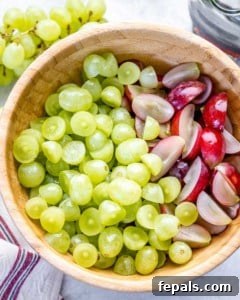 Sliced grapes in a brown wooden bowl