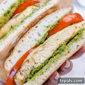 Gourmet Grilled Chicken Sandwich 12 hand holding sliced grilled chicken sandwich