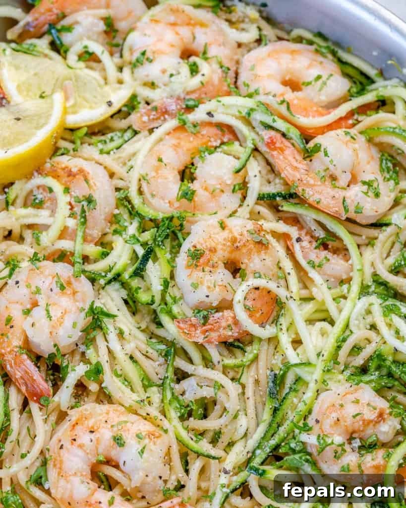 Zesty Lemon Shrimp Pasta with Zucchini Noodles 10 Detailed close-up of a serving of lemon garlic shrimp pasta, highlighting the juicy shrimp, tender pasta, and vibrant lemon and parsley.