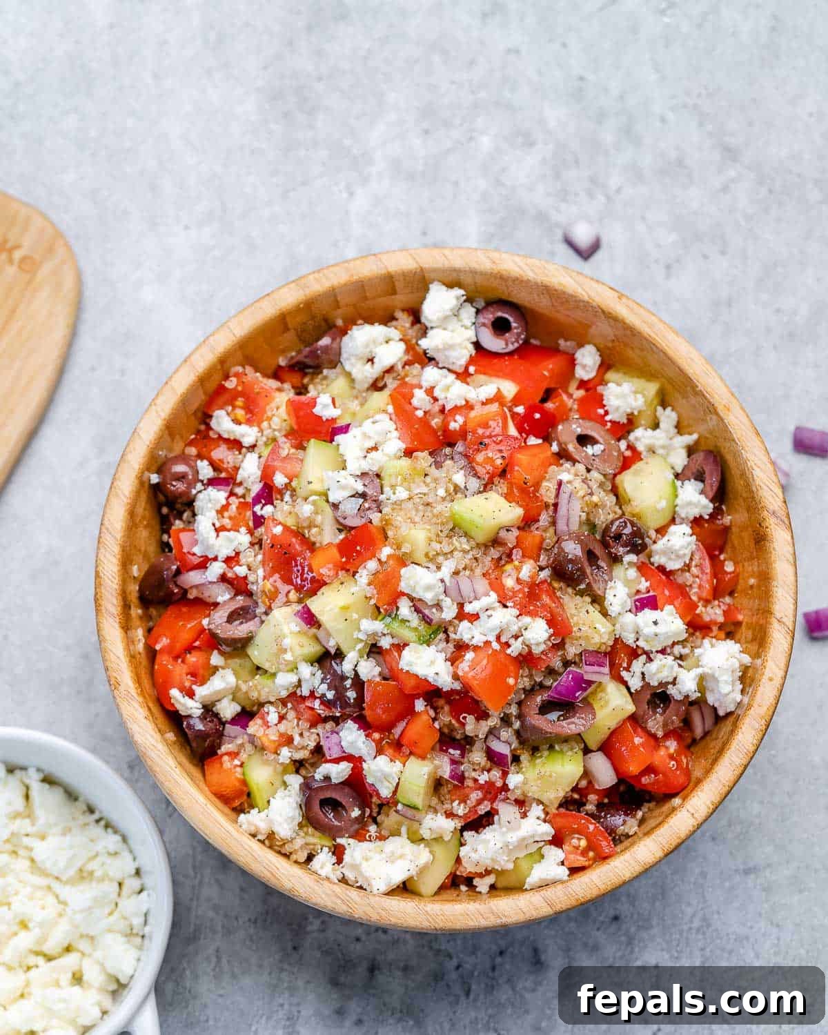 Greek Quinoa Salad Bowl Recipe With Feta Close-up of a quinoa salad bowl with feta cheese, showing vibrant colors and textures