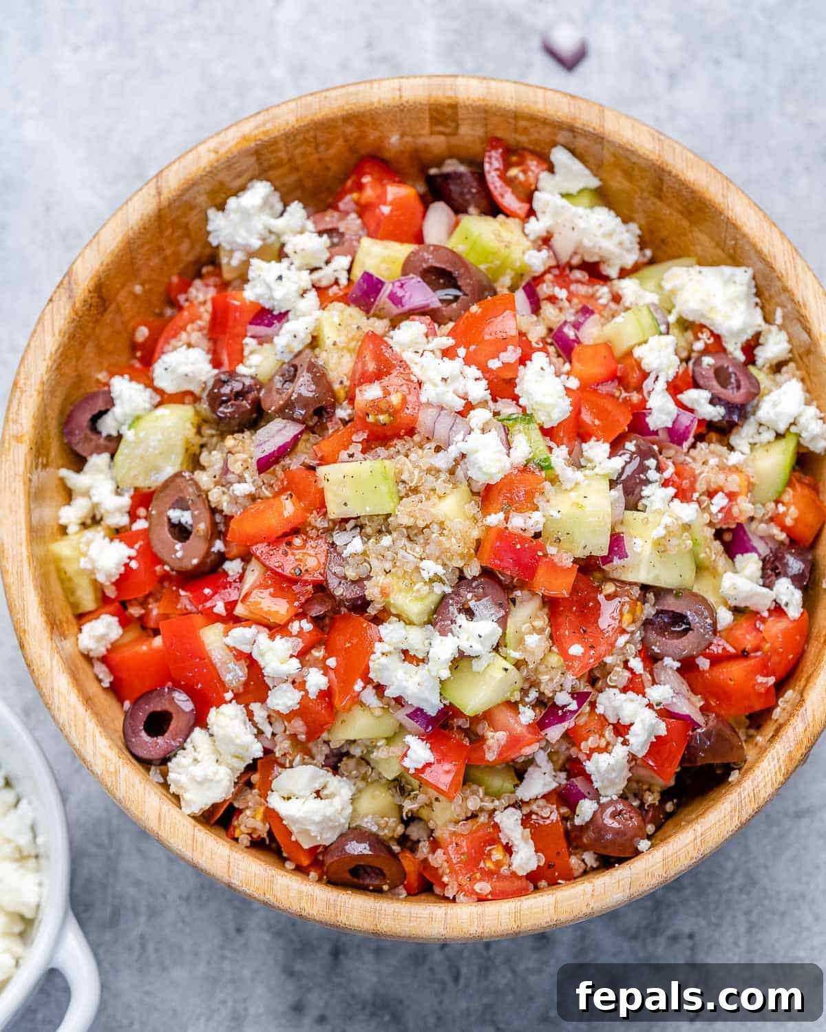 Zesty Greek Quinoa Bowl 2 Top view of Greek quinoa salad in a round bowl, garnished beautifully