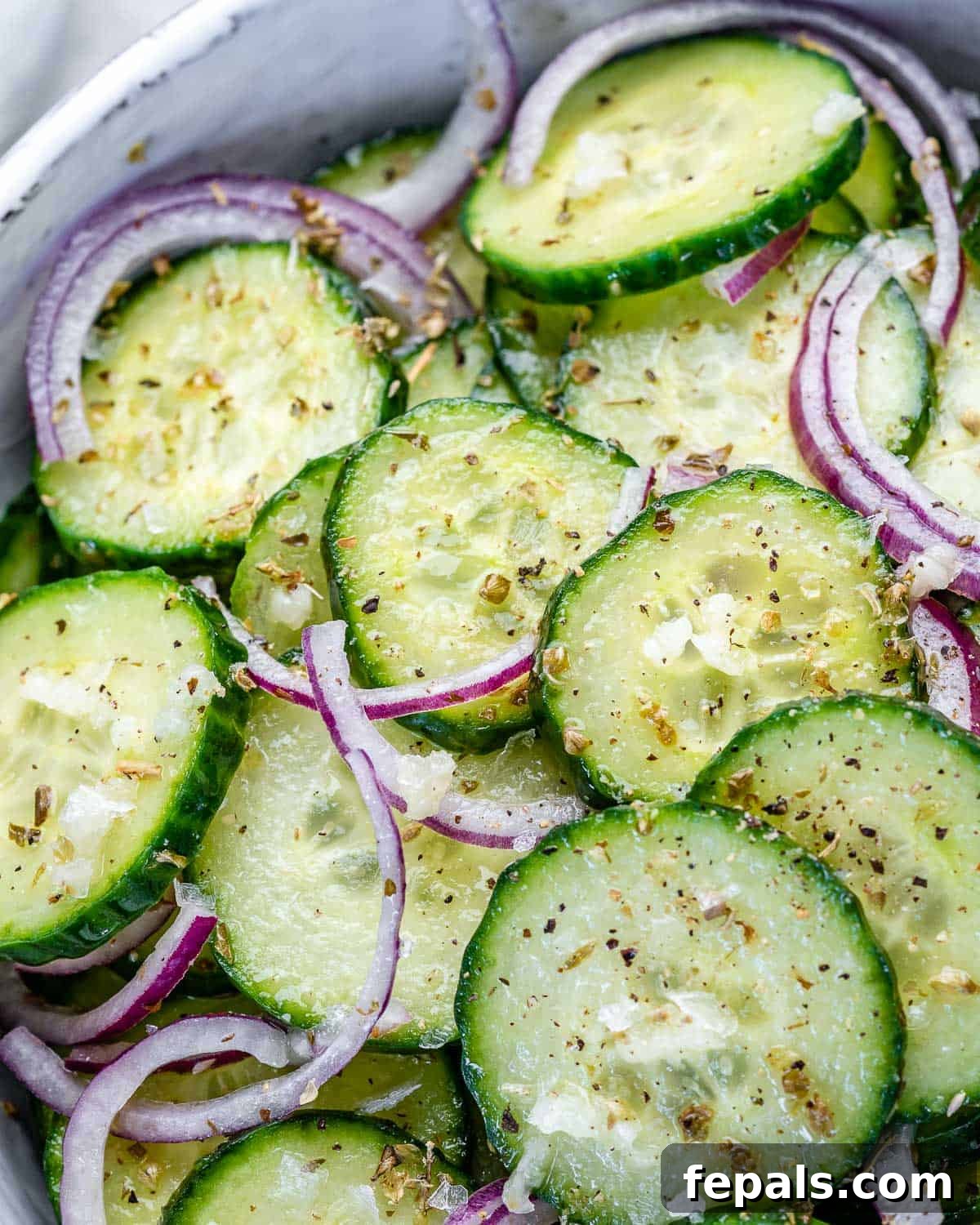 Cucumber Salad With Onions and Italian Dressing onion and cucumbers in bowl with Italian dressing