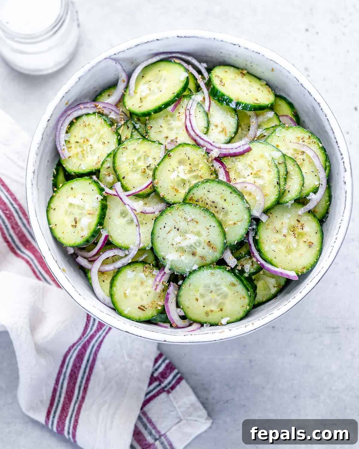 Cucumber and Onion Salad With Italian Dressing one bowl of cucumber salad with Italian dressing and onions