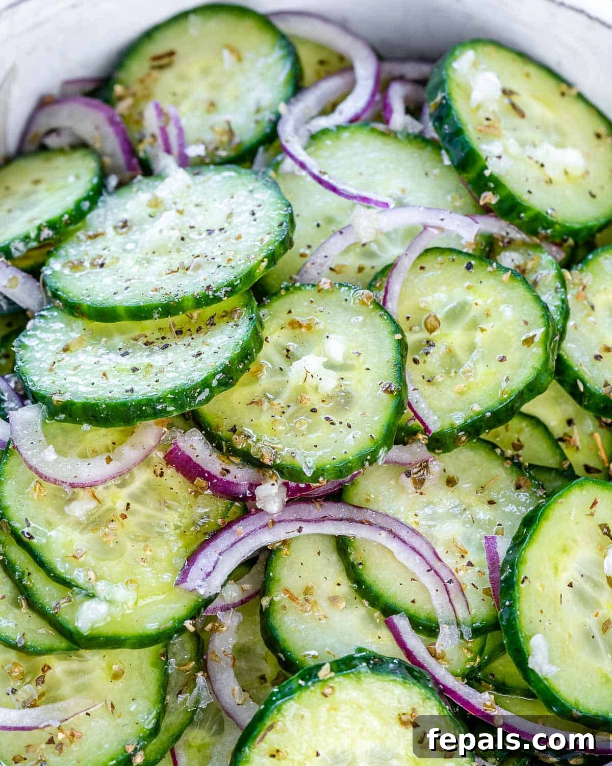 Cucumber Onion Salad Recipe cucumber onion salad in bowl with Italian dressing