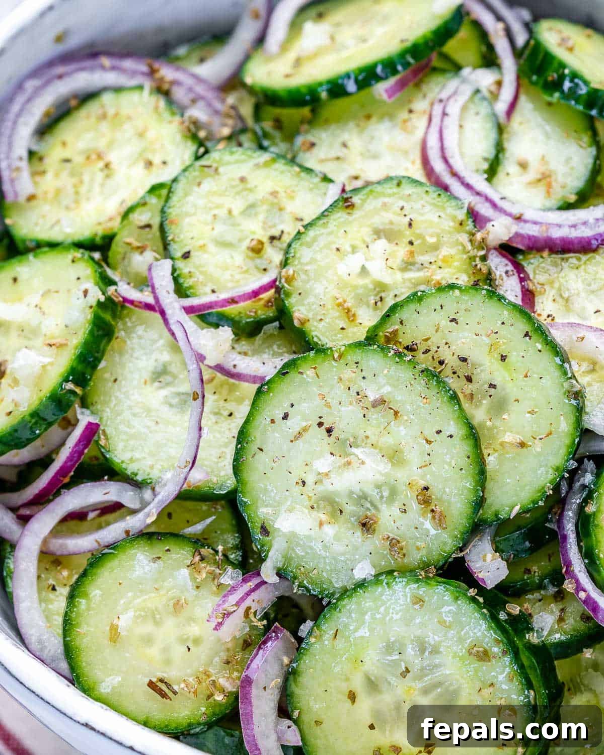 Cucumber and Onions in Vinegar onion and cucumbers in bowl with vinegar