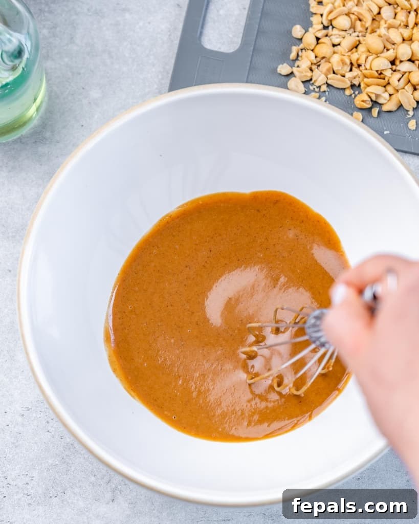 Creamy Thai Peanut Crunch 5 Mixing the Thai Salad Dressing with a whisk.