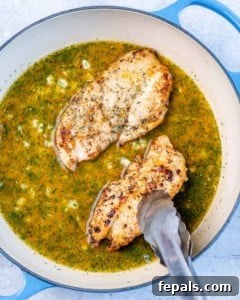 Zesty Lemon Chicken Breasts 7 cooking the chicken cutlets in chicken broth in skillet with tongs