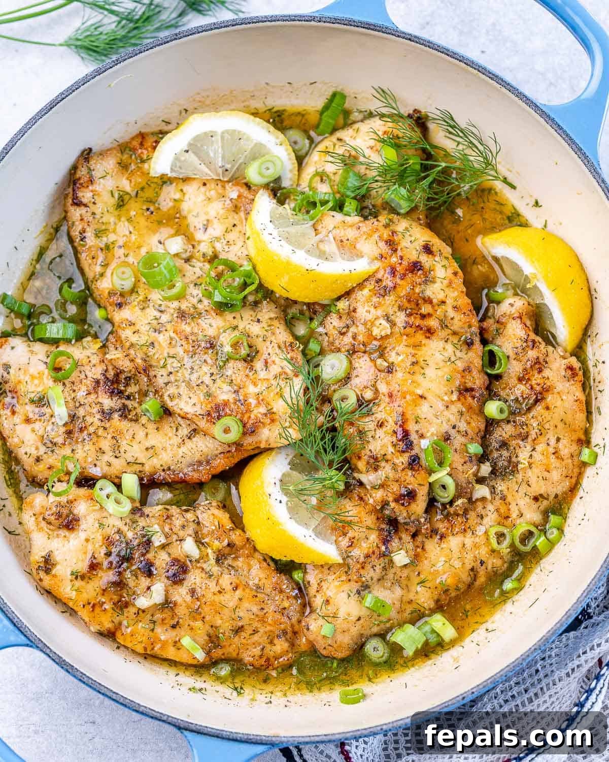 Easy Lemon Chicken Breast Recipe one skillet with lemon chicken breasts and lemon wedges