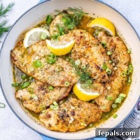 Zesty Lemon Chicken Breasts 5 top view lemon chicken breasts in a white pan with lemon garnishes