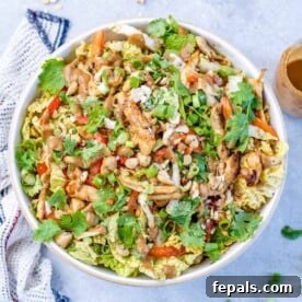 Top view of chinese chicken salad in a white bowl