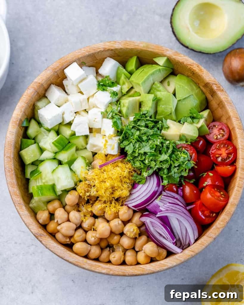 Chickpea Feta Salad ingredients individually placed in a wooden bowl (not mixed).