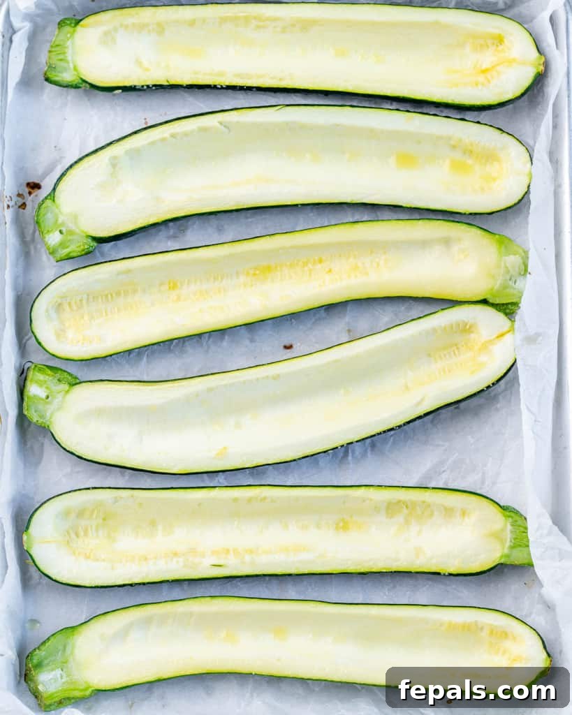 Overhead shot of freshly sliced zucchinis, perfectly hollowed out to create the ideal boats for stuffing.