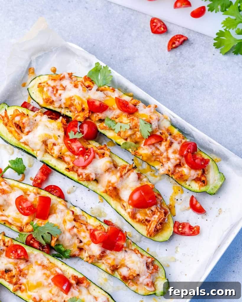 Zucchini Enchilada Bake 10 Several baked zucchini boats served directly on a baking pan, garnished with fresh herbs.