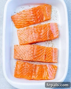 Raw salmon seasoned with salt and pepper.