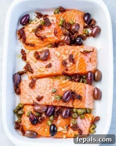 Salmon fillets topped with olives and capers.