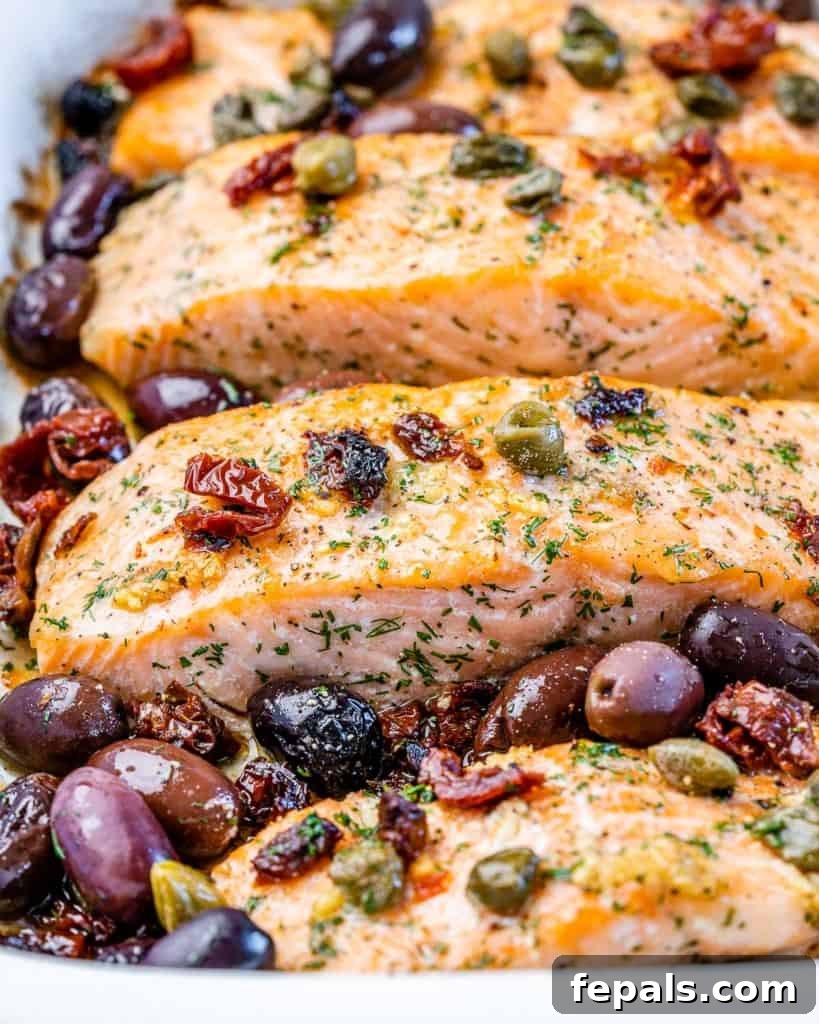close up of baked salmon with kalamata olives and capers