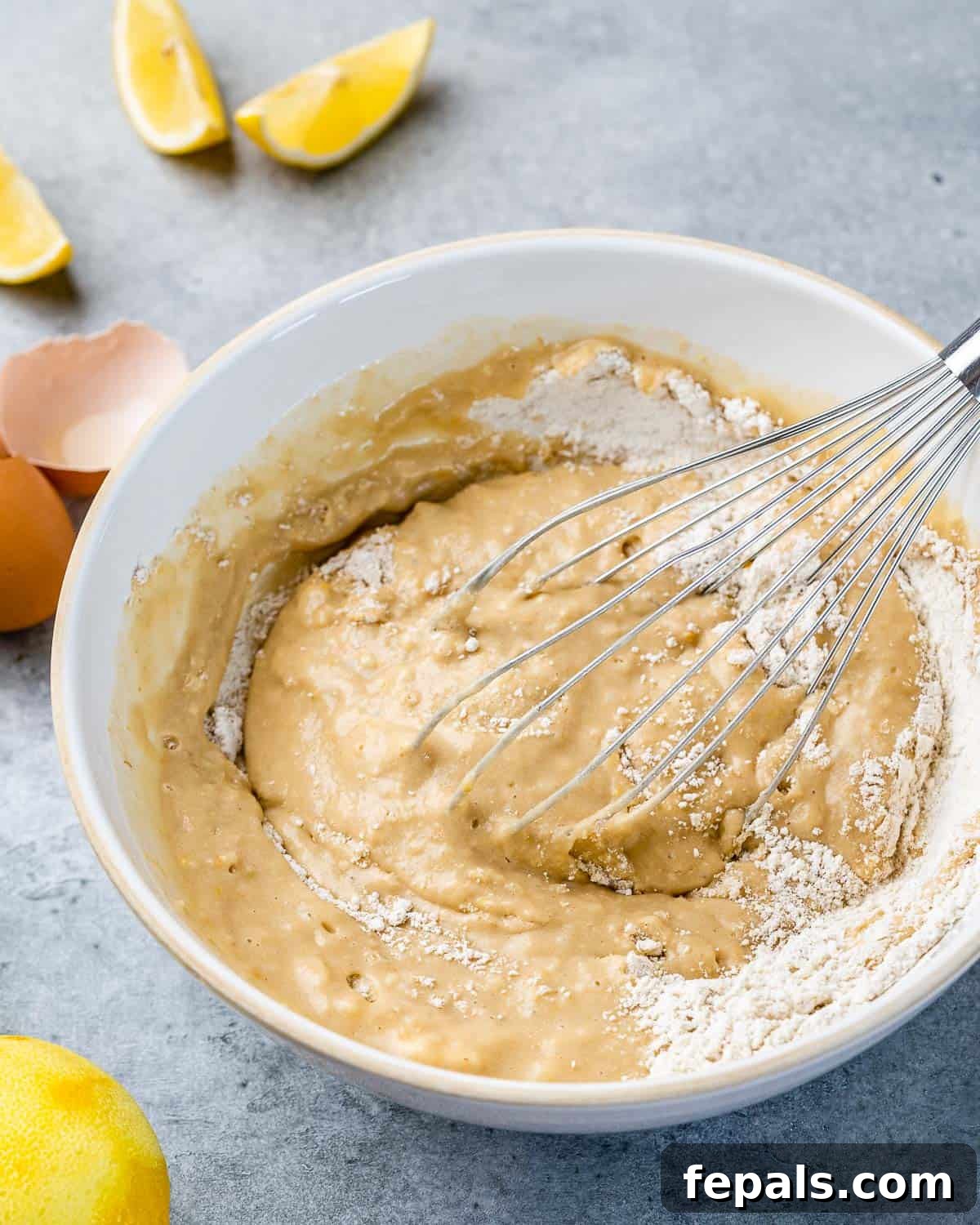 Combining wet and dry ingredients with a whisk.