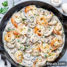 Garlic Shrimp in a Velvety Mushroom Sauce 12 top view of sauteed shrimp in a creamy mushroom sauce in a black skillet