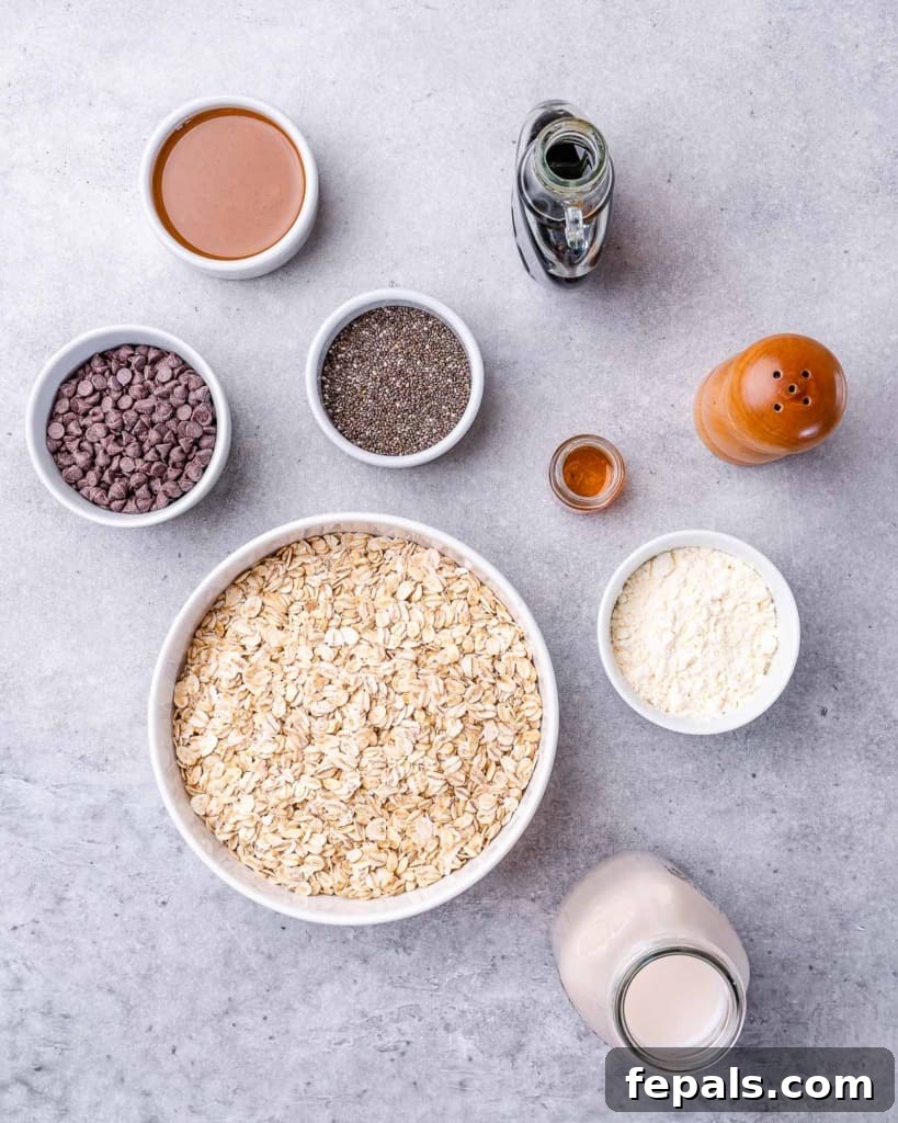 Guilt-Free Cookie Dough Oats 4 Geceden kalma yulaf yapmak için malzemeler küçük kaselere düzenli bir şekilde ayrılmış, kolay hazırlık için organizasyonu gösteriyor.
