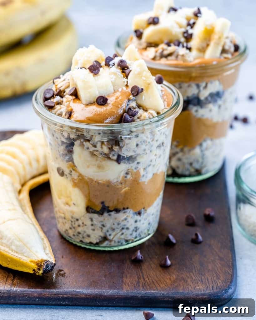 Side shot of Chunky Monkey Overnight Oats in a jar topped with sliced bananas and chocolate chips, showcasing its creamy texture.
