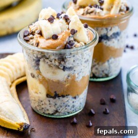 side shot of overnight oats in a jar topped with sliced bananas and chocolate chips