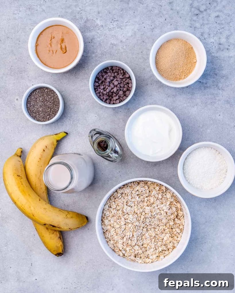 Ingredients for Chunky Monkey Overnight Oats divided into small bowls, showing oats, chia seeds, sweeteners, and toppings.