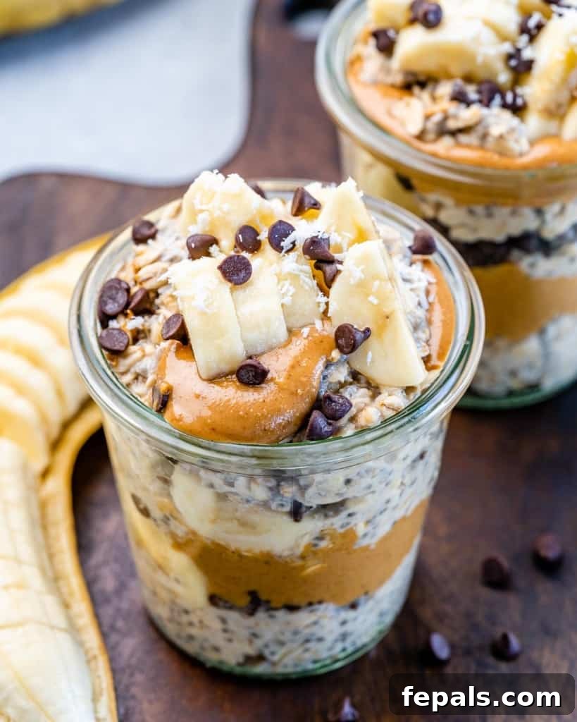 Peanut butter layered with overnight oats in a glass jar, ready for more toppings.