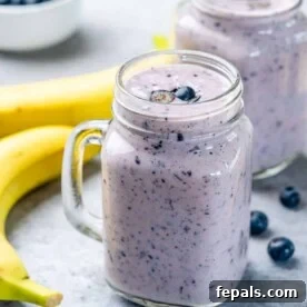 A delicious blueberry banana smoothie in a mason jar, perfect for a healthy breakfast or snack.