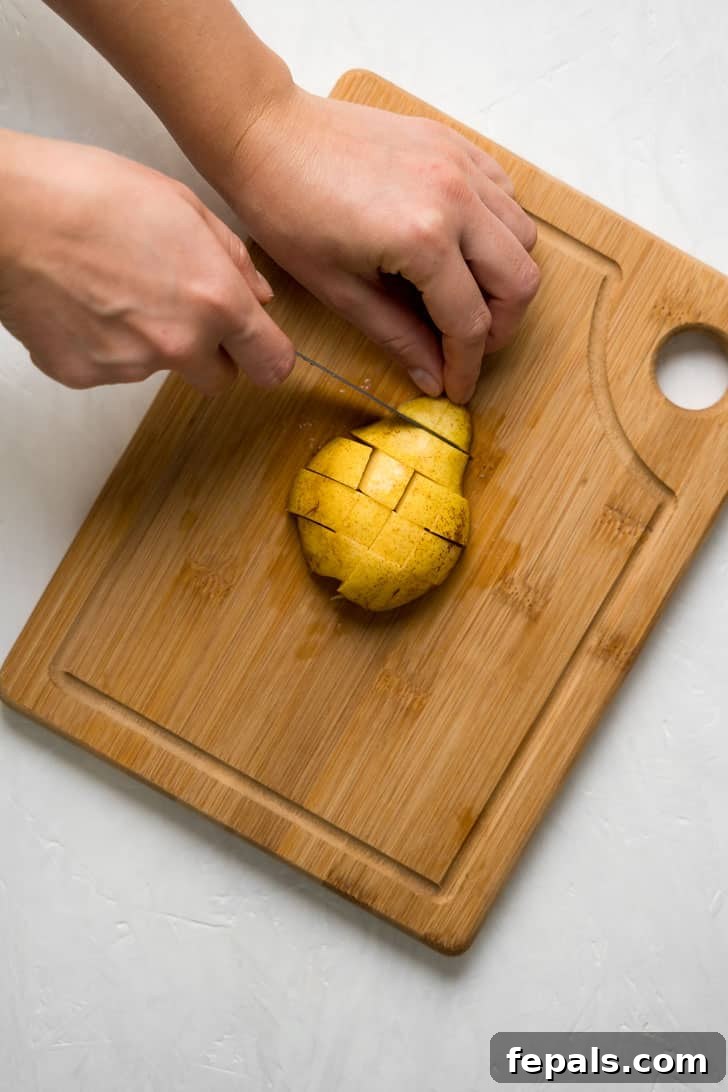 How to Cut a Pear Into Slices A sharp knife meticulously cuts across pear slices on a wooden board, transforming them into perfect cubes.
