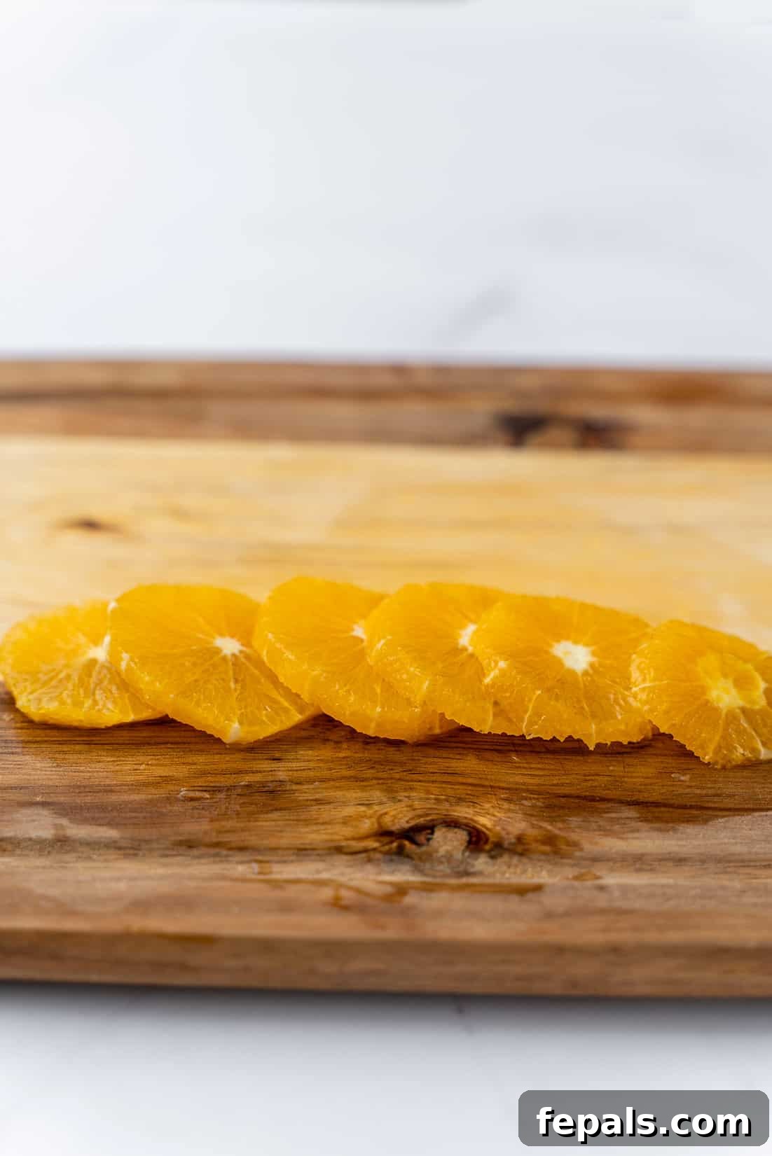Beautiful, juicy orange rings displayed on a cutting board, ready to be served or used.