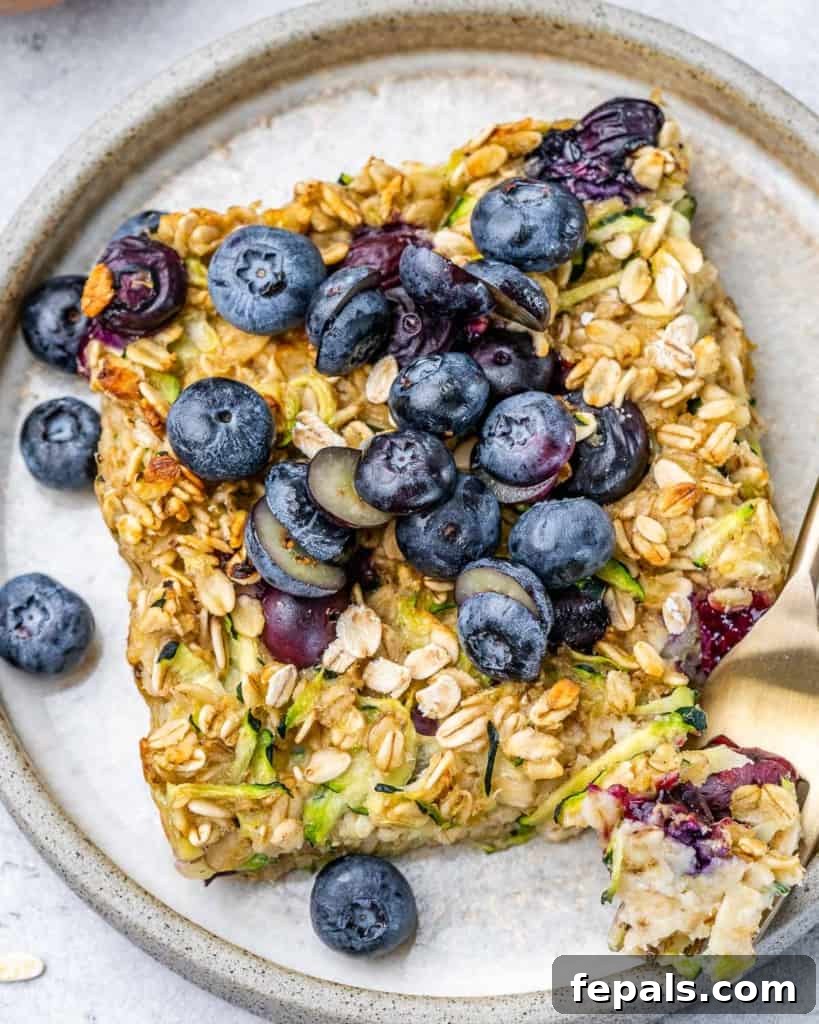 Slice of baked oatmeal topped with blueberries.