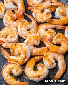Large shrimp cooking in a skillet.