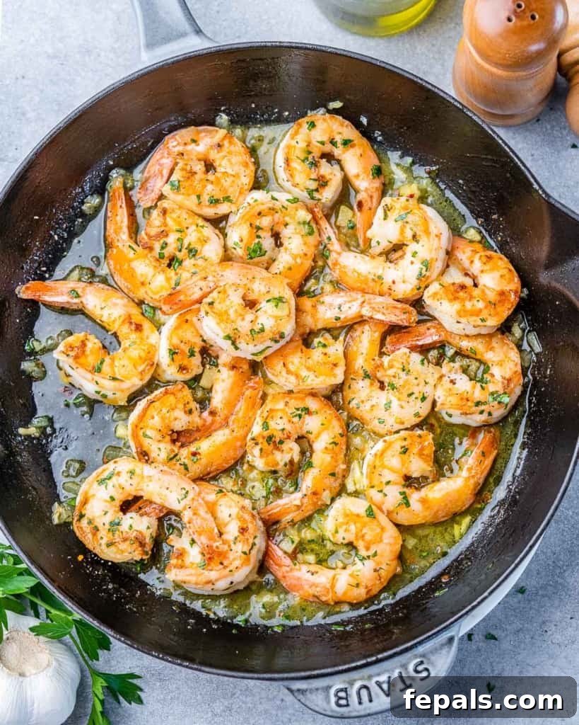 Guilt-Free Garlic Shrimp Scampi 15 top view shrimp scampi cooked in a black skillet, ready to serve