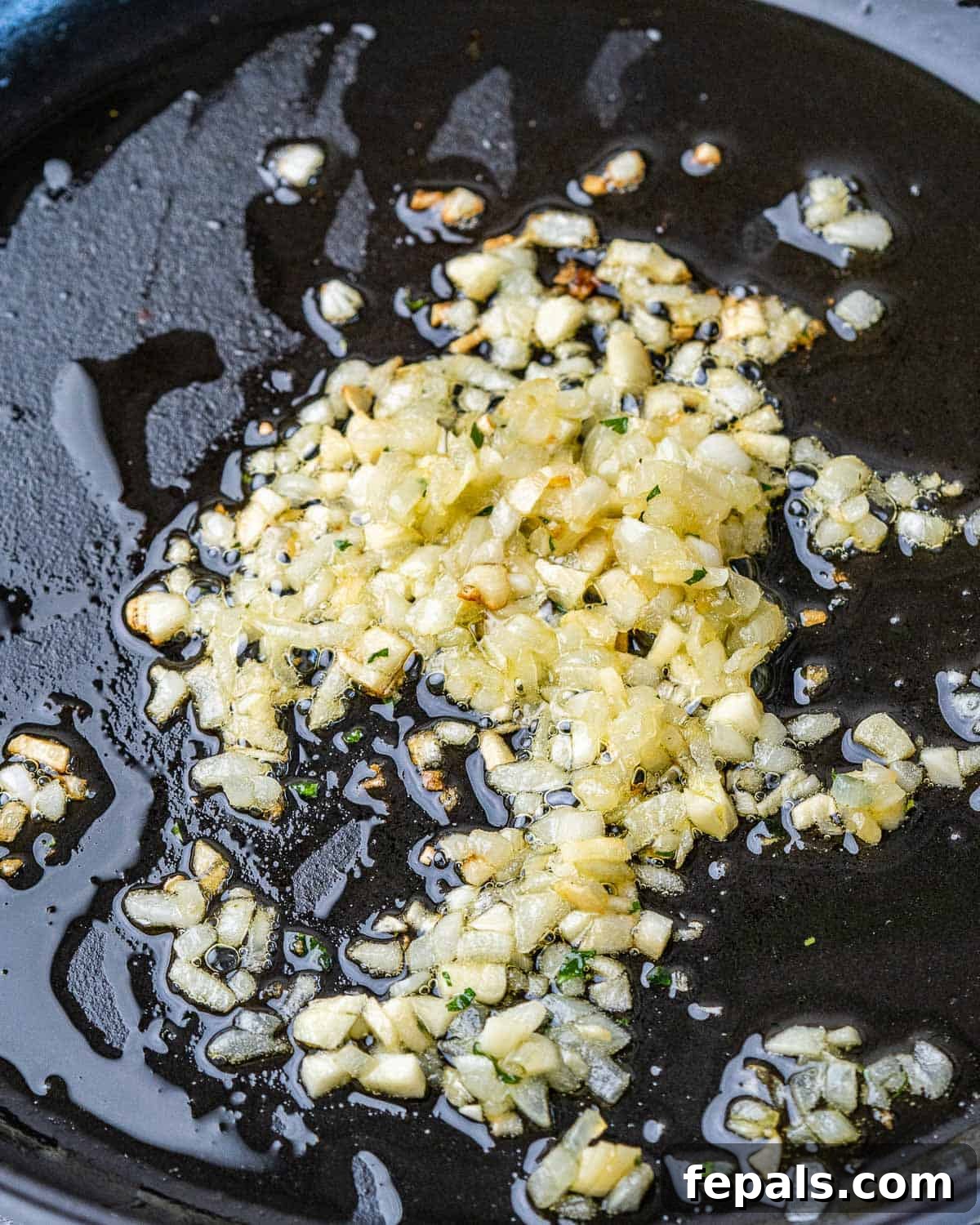 Guilt-Free Garlic Shrimp Scampi 6 Cooking garlic and onion in a skillet with olive oil for the scampi sauce