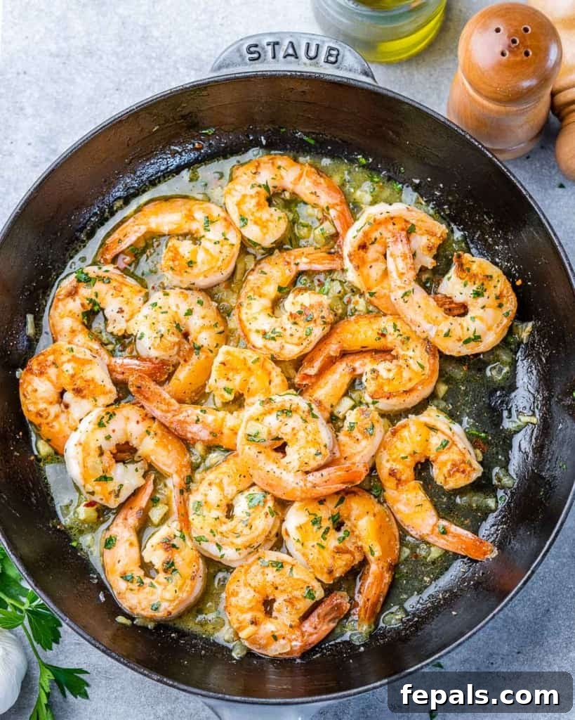 Guilt-Free Garlic Shrimp Scampi 9 Shrimp scampi cooking in a large skillet, close-up with fresh ingredients