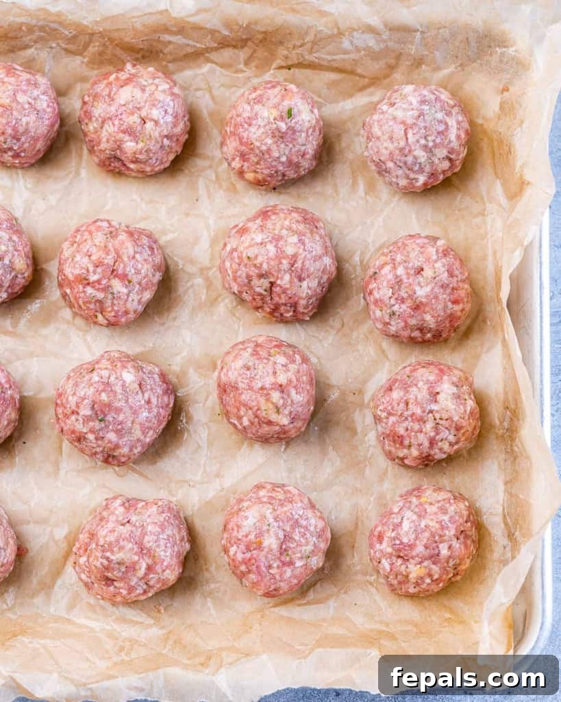 Nonna's Italian Wedding Soup 5 Raw meatballs on a parchment lined baking sheet.